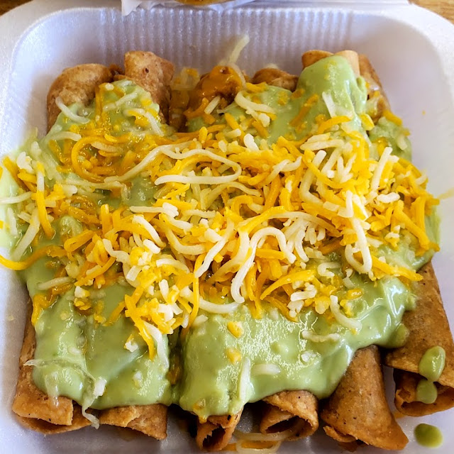 Six Rolled Beef Tacos with Guacamole and Cheese