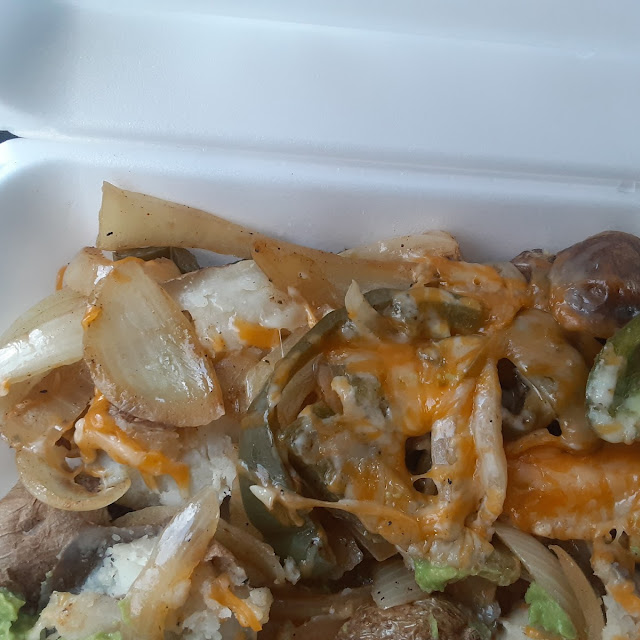 Vegetarian Baked Potato with Peppers Onions and Shredded Cheese