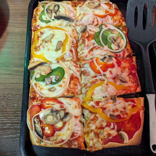 Thick Pizza with Mushrooms Peppers and Onions