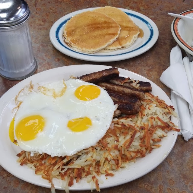 Two Eggs Hash Browns or Grits Toast Pancakes