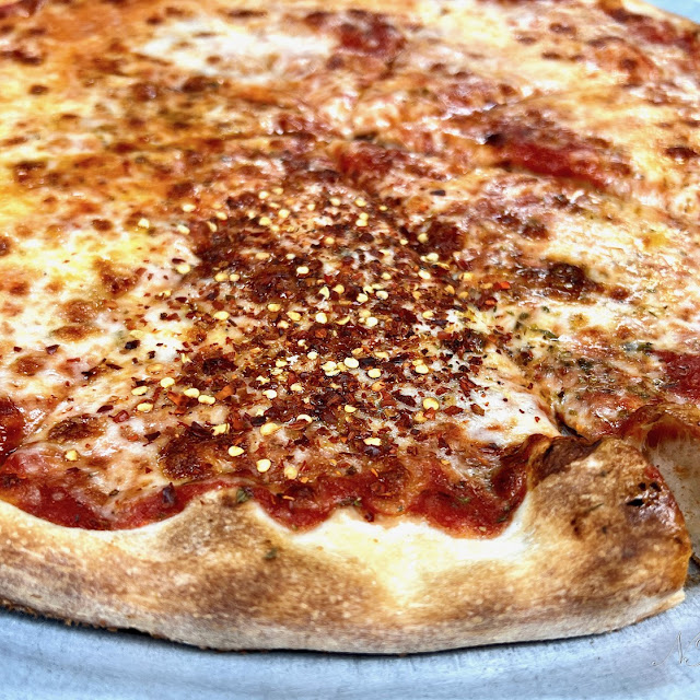 New York Style Pizza Slice with Chili Peppers Flakes