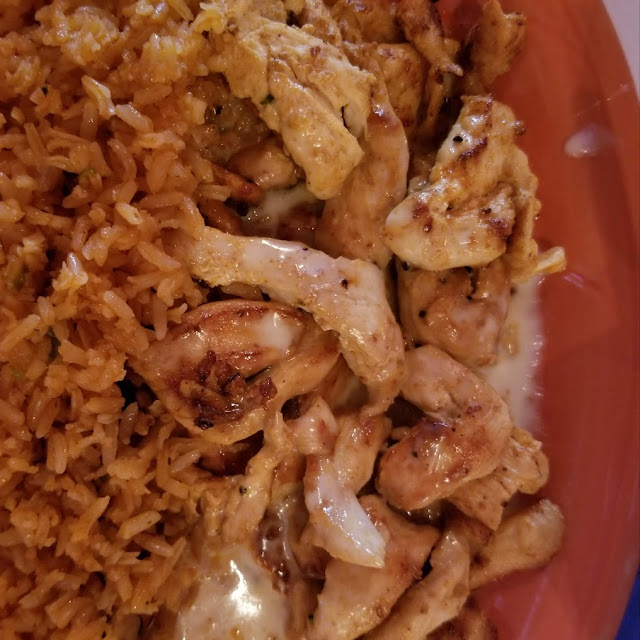 Grilled Chicken on a Bed of Rice Topped with Cheese Sauce
