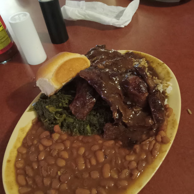 Pork Chops Rice and Gravy Pinto Beans Mixed Greens