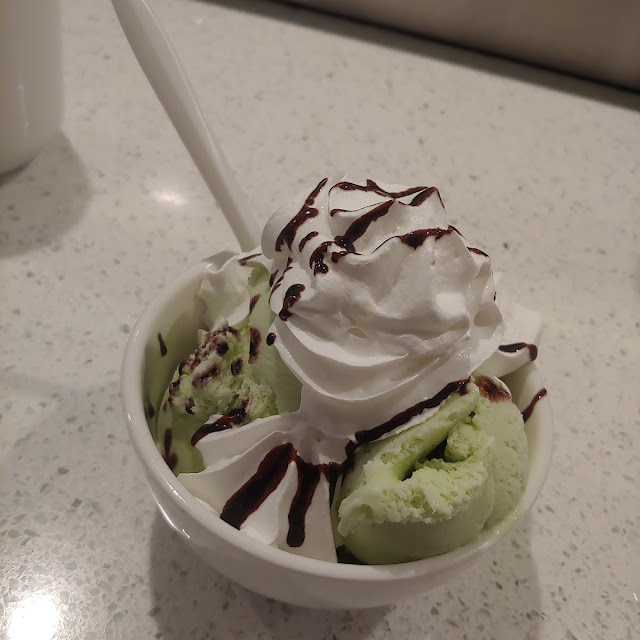 Matcha Green Tea Ice Cream with Whip Cream and Chocolate Syrup