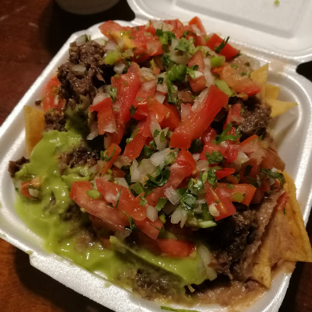 Nachos Chicos Con Carne with Meat Cheese Sour Cream Mexican Salsa Guacamole and Fred Beans