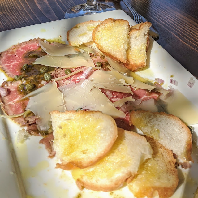 Carpaccio Drizzled with Oil Topped with Parmesan and Capers Great with a Crisp Cold White Wine